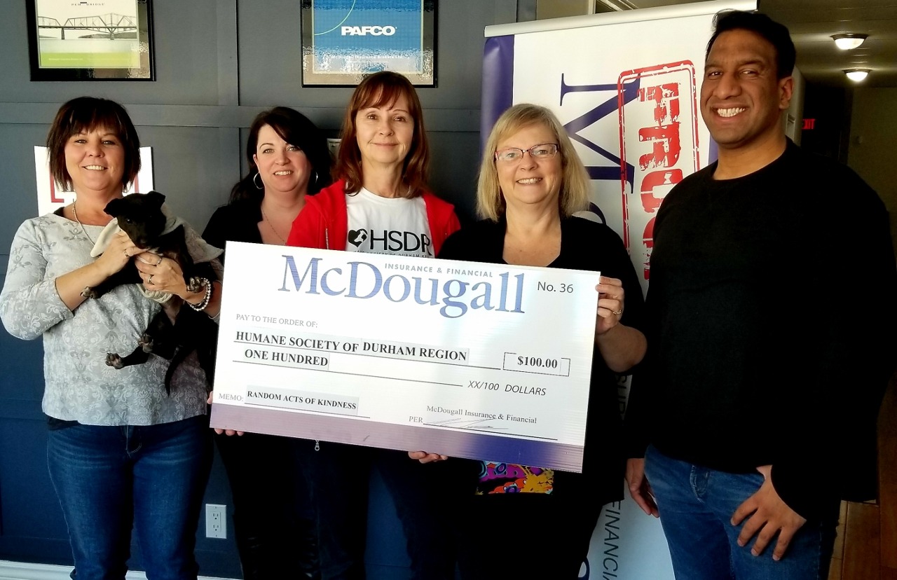5 people and puppy from the Humane Society receive donation cheque from McDougall