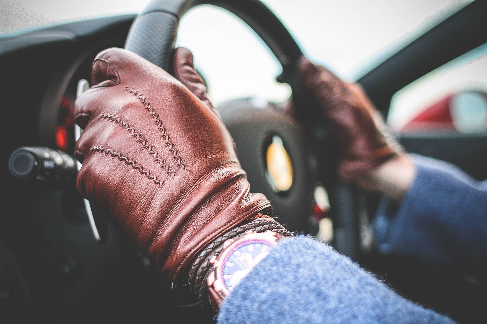 Driver wearing gloves, hands on the wheel