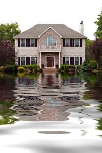 Flooding and potential damage outside a large home