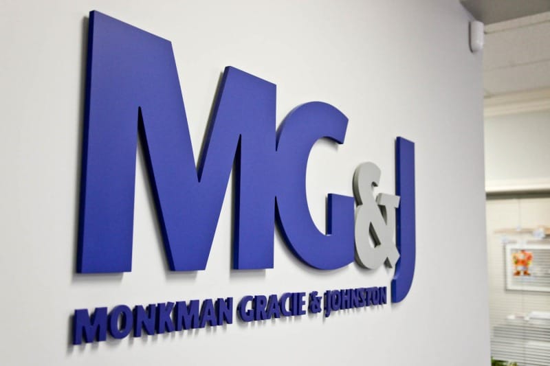 Monkman Gracie and Johnston Insurance Sign in office building