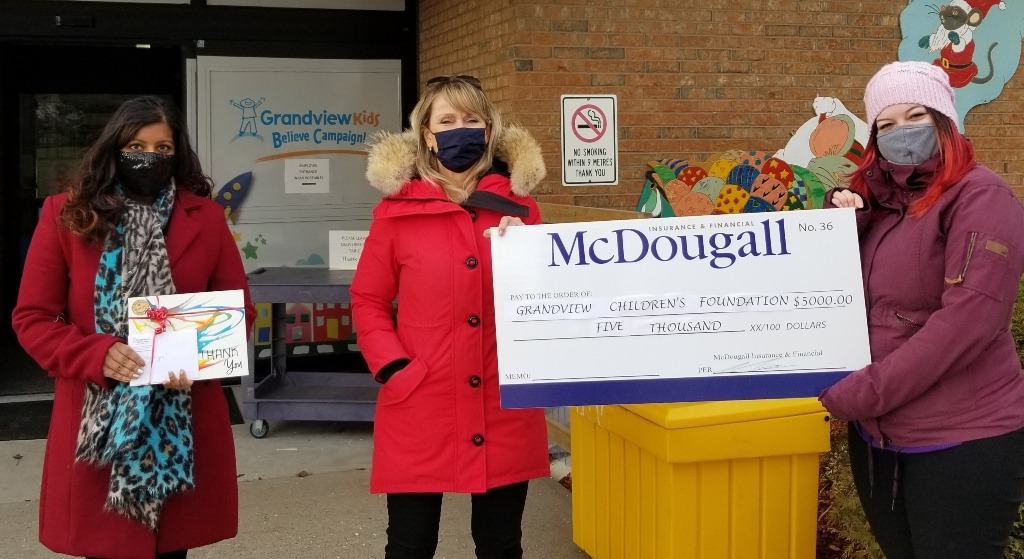 Three people hold giant cheque worth $5000 to Grandview Children's Foundation