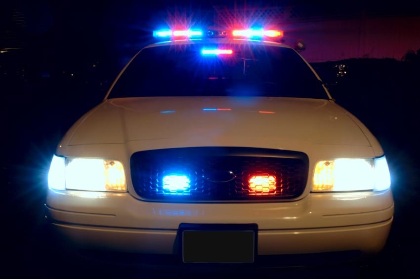 police car with lights illuminated at night