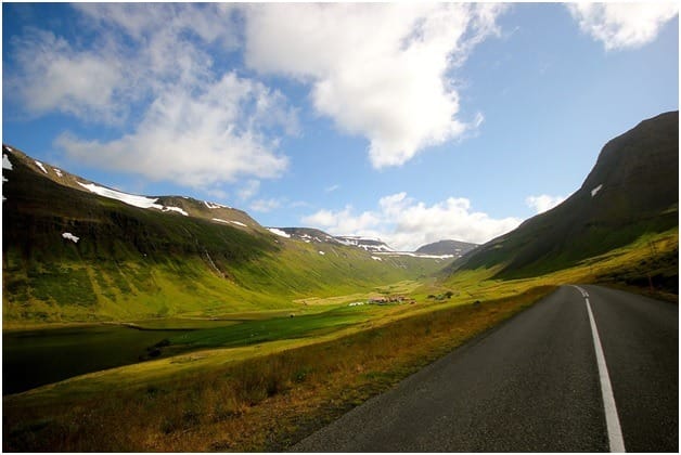 Open empty road with rolling hills in the background