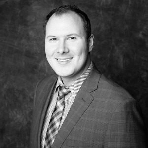 Timothy Hutchison smiling, black and white background