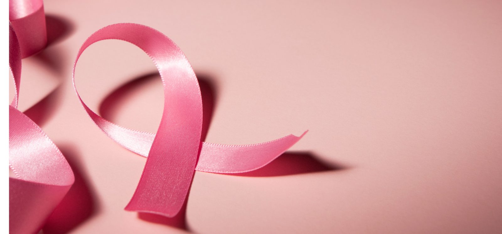 pink breast cancer ribbon with a pink background