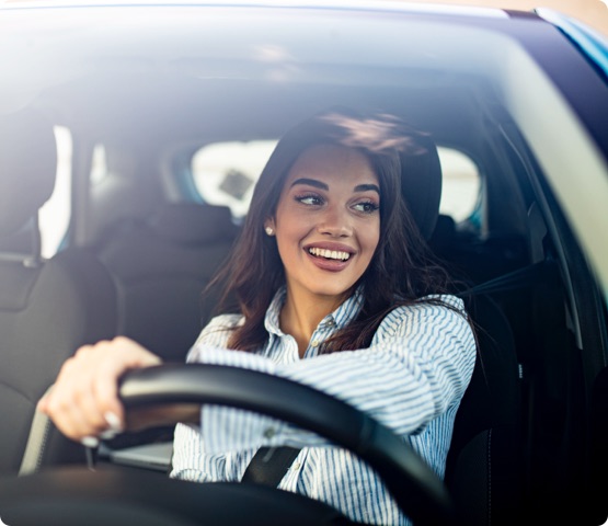 person driving a car and smiling