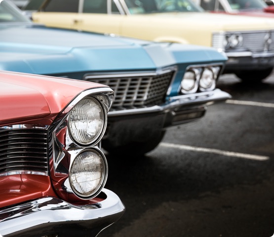 Classic cars parked on asphalt parking lot