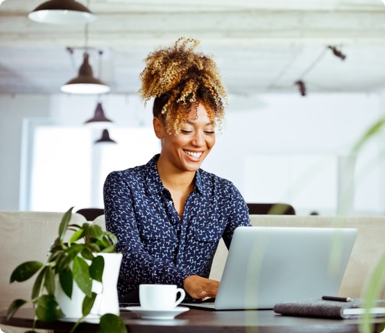 Business person using laptop in office. She is working on an investment plan.