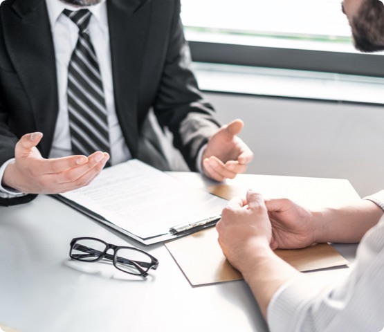 Business people negotiating a contract. Human hands working with documents at desk and signing contract.