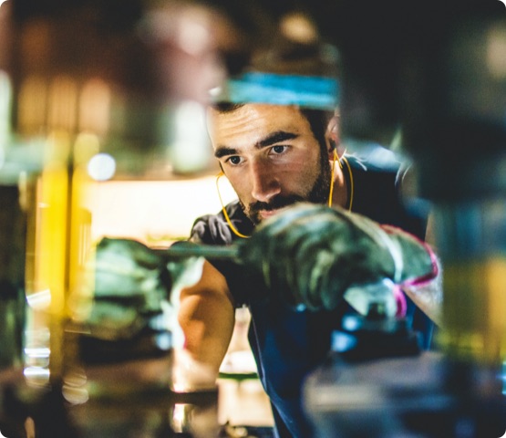 Worker Repairs Cold Forging Machine