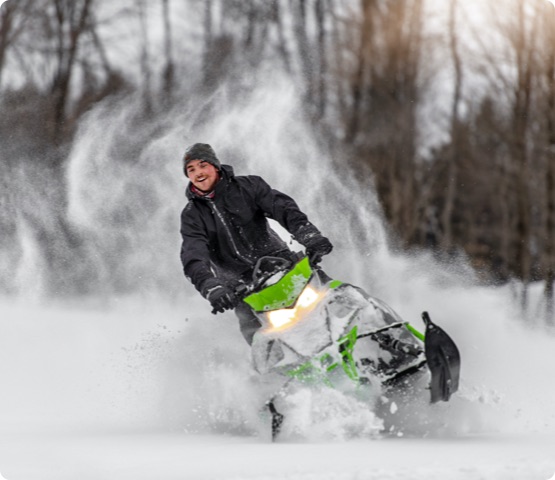 Person riding snowmobile in the mountains in winter, Quebec, Canada