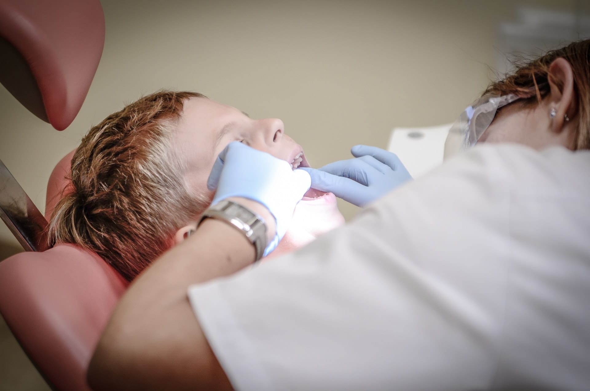 Kid having teeth looked at by a dental technician