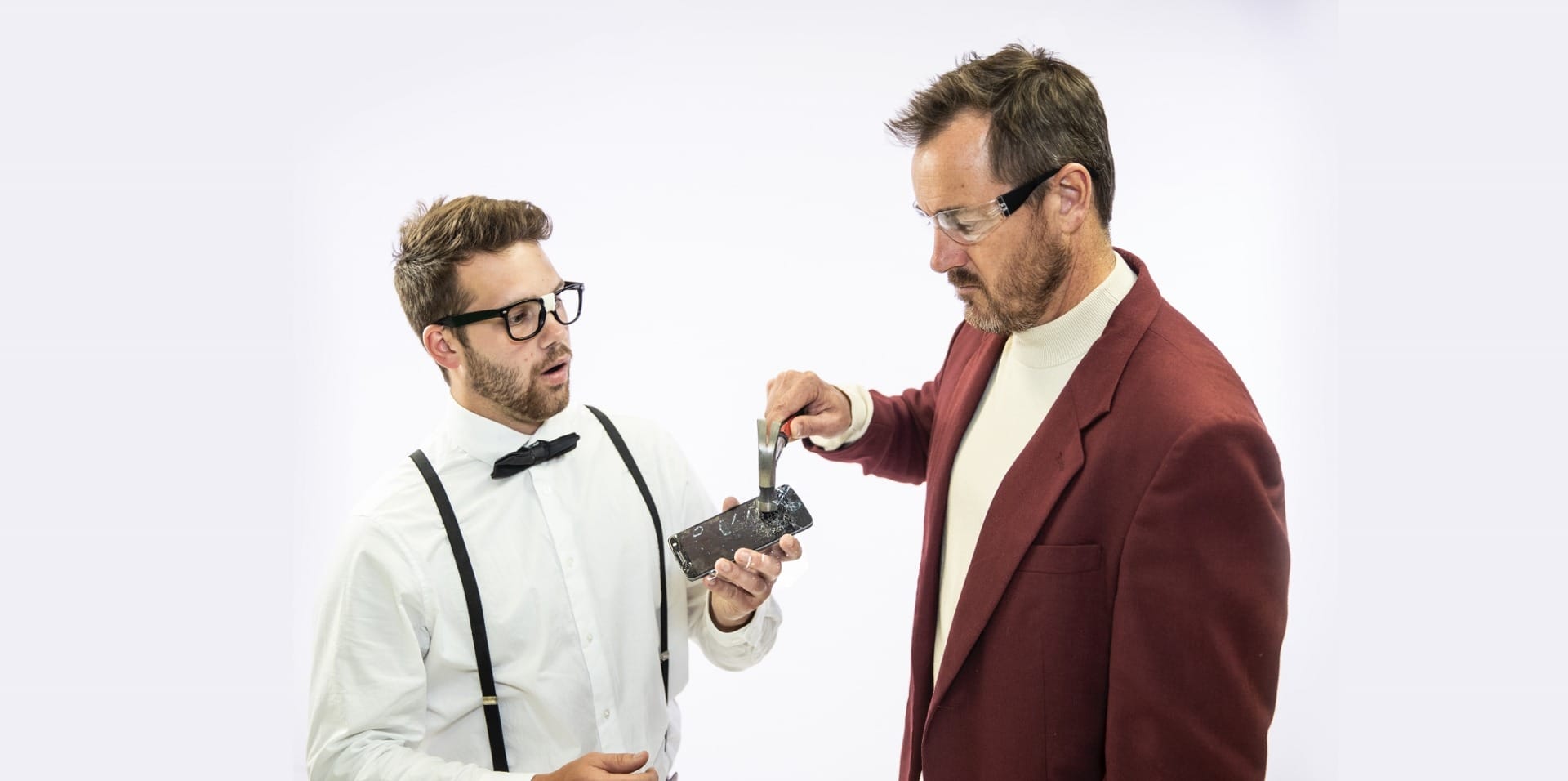 2 people inspecting broken mobile phone