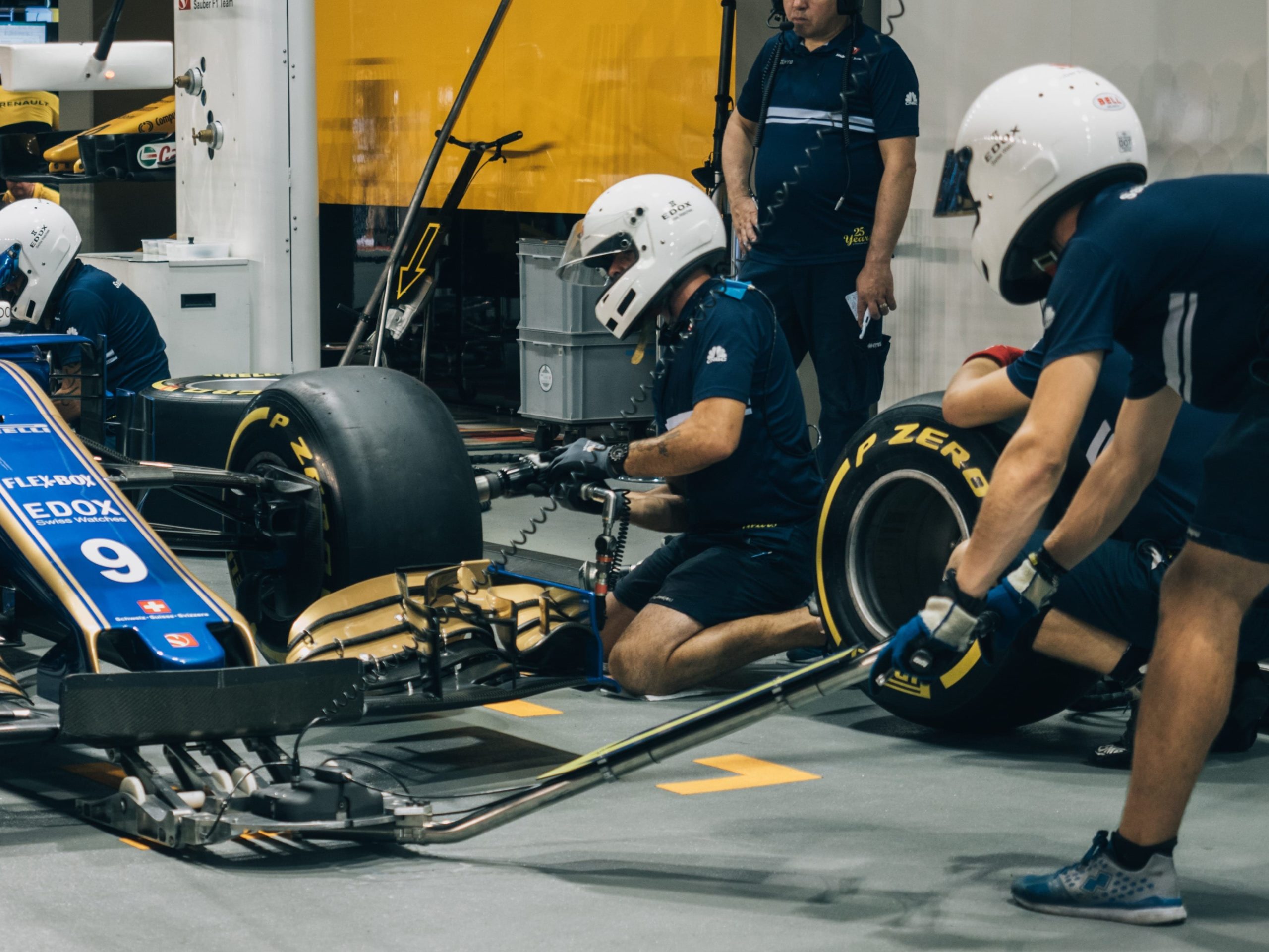 racecar pit crew changing tires 