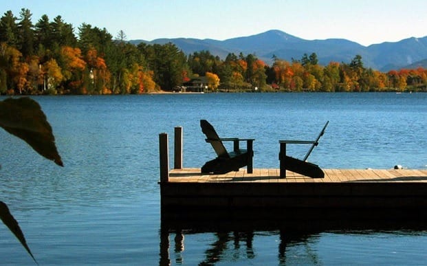 fall scene with dock and chairs looking out to the water to show last weekend of summer