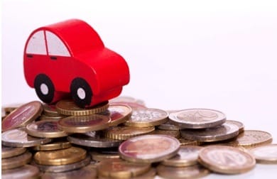 Ilustration of a tiny red car on a mound of nickels and quarters