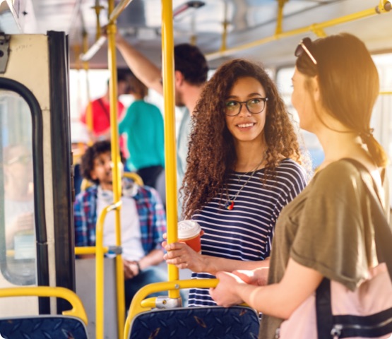 Two girls talking while wait for bus to move.