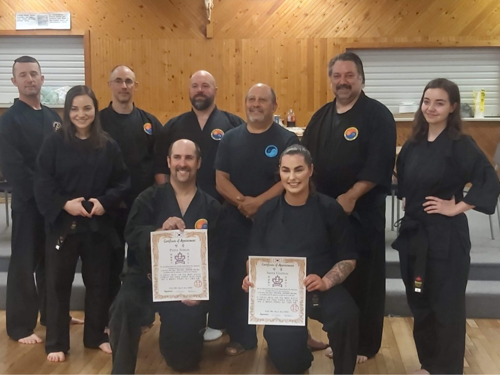 Sarra Gratton receiving martial arts certificate of achievement 